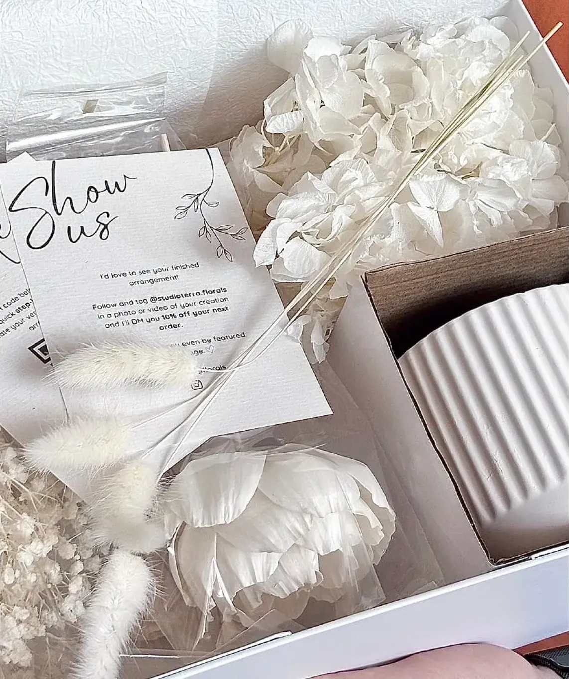 Studio Terra DIY floral kit — a hand-packed box of preserved botanicals, a ceramic vessel and an instruction card.