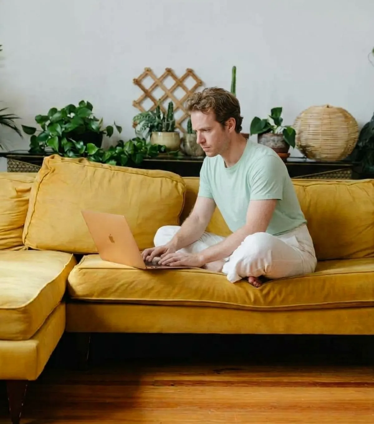A man writing his Will on a laptop at home