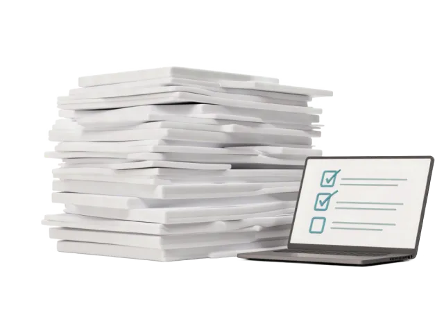 A stack of paperwork next to a laptop